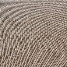 Load image into Gallery viewer, Close-up of the Osiris carpet by New Weave, a circular beige jacquard woven rug made with ECONYL® regenerated nylon and a subtle geometric pattern.