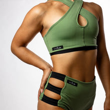 Load image into Gallery viewer, Woman wearing a green sports bra and high-waisted shorts with 'Vvita' branding on a white background