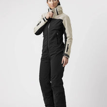 Load image into Gallery viewer, A female model wearing a white and black ski suit by Hey Sport, made with ECONYL® regenerated nylon.