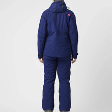 Load image into Gallery viewer, A woman wearing a blue ski jacket with red zip details by Hey Sport, made with ECONYL® regenerated nylon.