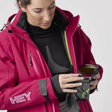 Charger l'image dans la galerie, A woman wearing a pink ski jacket with full zipper by Hey Sport, made with ECONYL® regenerated nylon.