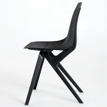 Charger l'image dans la galerie, Side view of a black Noho Move chair made with ECONYL® regenerated nylon.