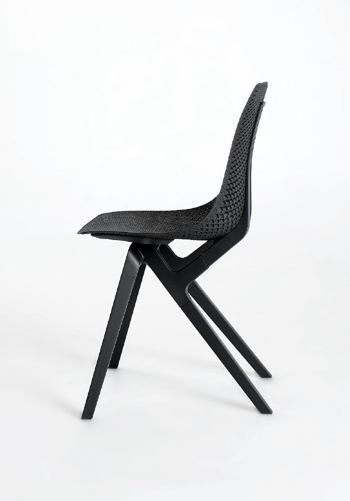 Side view of a black Noho Move chair made with ECONYL® regenerated nylon.
