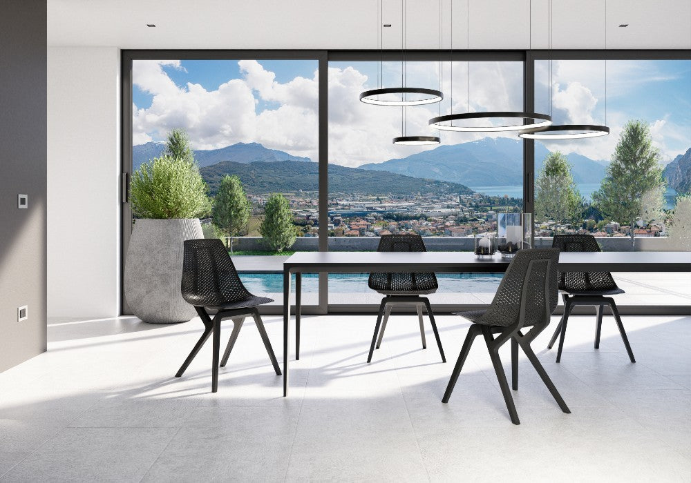Living room with black Noho Move chairs made with ECONYL® regenerated nylon.