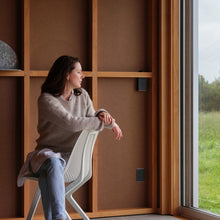 Charger l'image dans la galerie, Woman sitting on a white Noho chair made with ECONYL® regenerated nylon.
