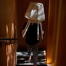 Charger l'image dans la galerie, Man holding a white Noho Move chair made with ECONYL® regenerated nylon.