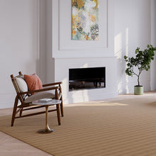 Charger l'image dans la galerie, A stylish rug by Synsisal, made from ECONYL® regenerated nylon, in a living room setting with a fireplace, wooden rocking chair, and potted plant.