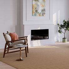 Charger l'image dans la galerie, A stylish rug by Synsisal, made from ECONYL® regenerated nylon, in a living room setting with a fireplace, wooden rocking chair, and potted plant.