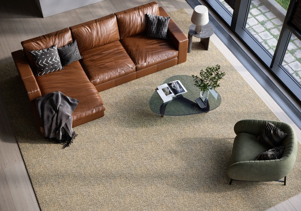 A stylish rug by Synsisal, made from ECONYL® regenerated nylon, in a living room setting with sofa