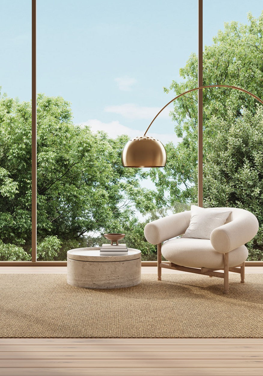 Modern living room with a beige SynSisal weave rug, a white sofa in the center, and a window overlooking a green field.