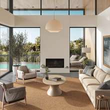 Load image into Gallery viewer, A stylish rug by Synsisal, made from ECONYL® regenerated nylon, in a modern living room setting with sofa