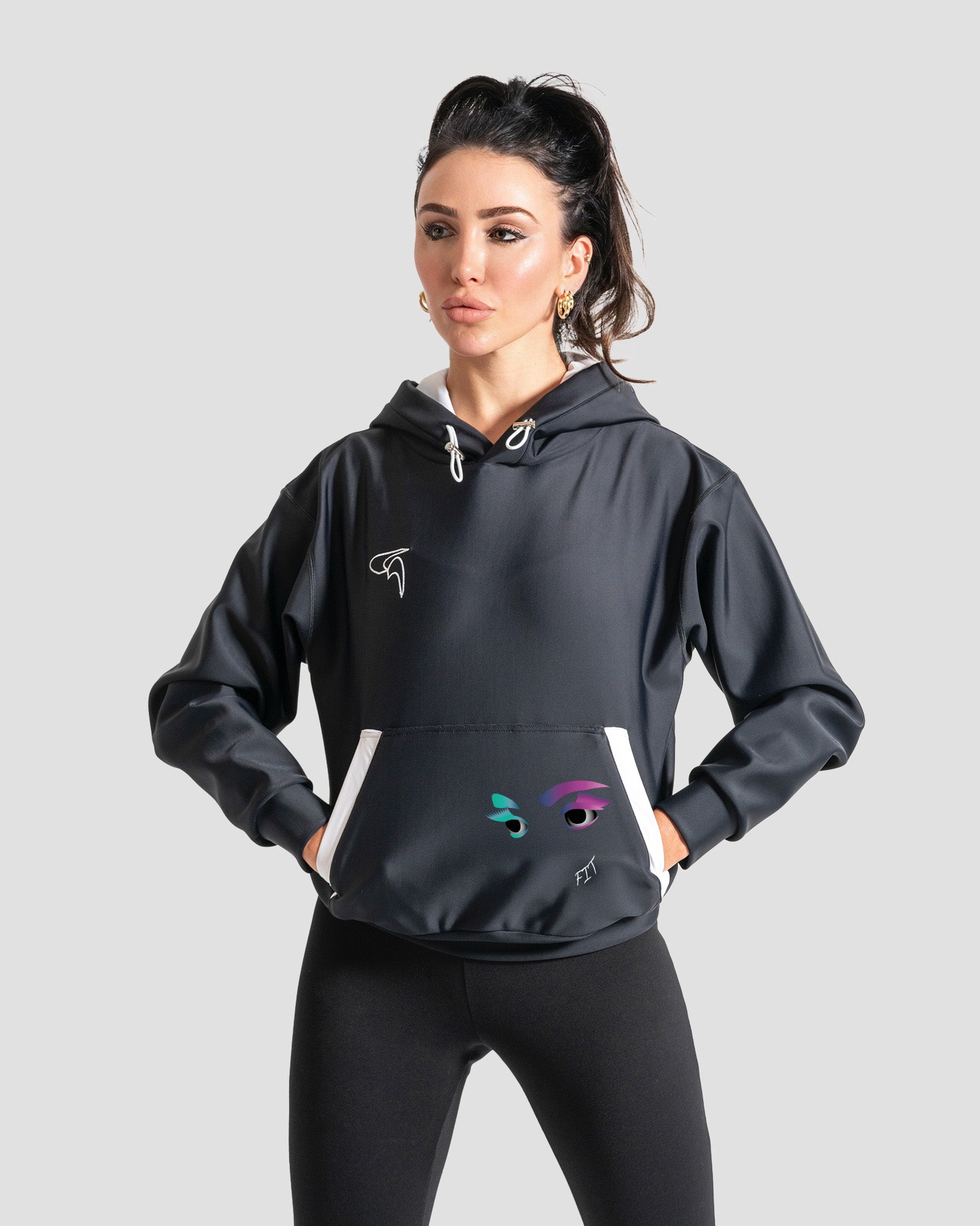 A woman modeling a black athletic pullover hoodie by the brand GoofyPRO with white drawstrings, made with ECONYL®nylon   