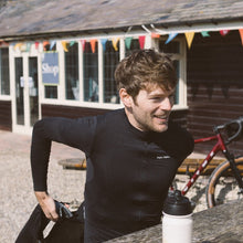 Load image into Gallery viewer, Man wearing the Angry Pablo EarthTone Riding Jersey color Black made with ECONYL® regenerated nylon
