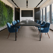 Charger l'image dans la galerie, Modern conference room with a large table and blue chairs, featuring a living wall and cityscape view. Rug by Synsisal made with ECONYL® regenerated nylon
