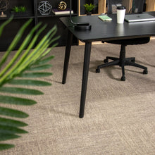 Charger l'image dans la galerie, Black office desk in a modern office setting with plants and office supplies. Rug by Synsisal made with ECONYL® regenerated nylon
