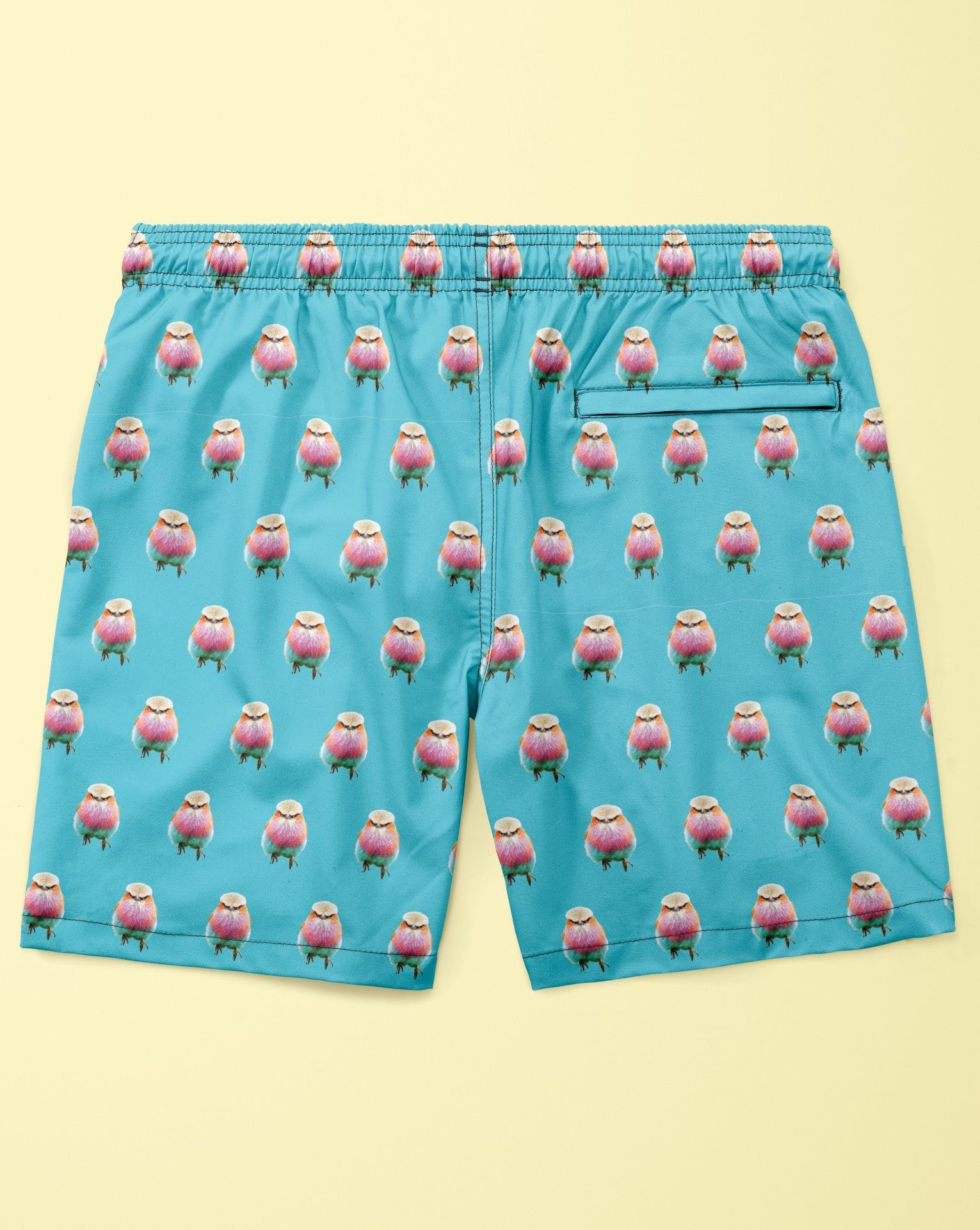 Blue shorts with a pink and green pattern on a yellow background
Made with econyl nylon