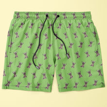 Load image into Gallery viewer, Green swim shorts made with econyl nylon with raccoon pattern on a beige background

