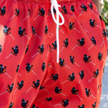 Load image into Gallery viewer, Red swimming shorts with pigeon motif, made with econyl nylon
