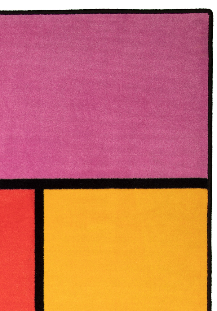 A colorful geometric carpet with bold blocks of color. Limited edition art piece by Ugo Rondinone, made with ECONYL® yarn.