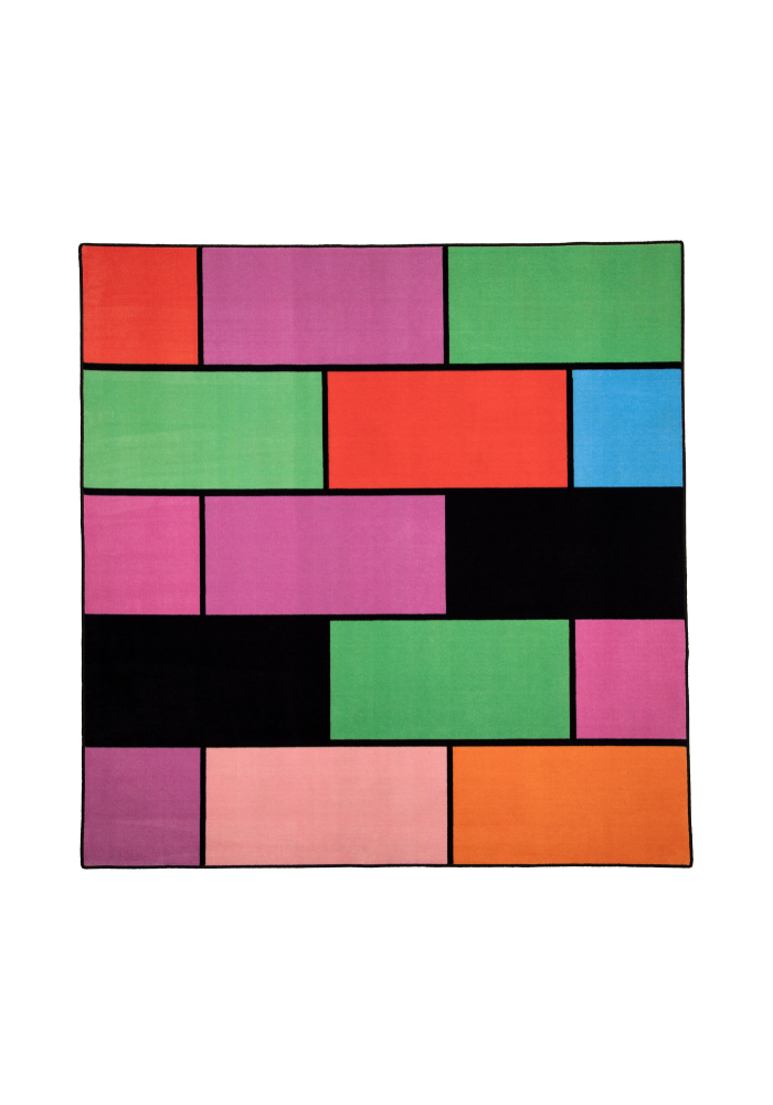 A colorful geometric carpet with bold blocks of color. Limited edition art piece by Ugo Rondinone, made with ECONYL® yarn.