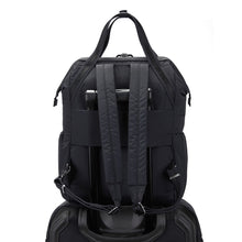 Charger l&#39;image dans la galerie, Back view of the Pacsafe Citysafe CX Anti-Theft Backpack color Black made with ECONYL® regenerated nylon on a luggage
