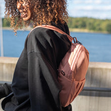 Charger l&#39;image dans la galerie, Woman walking with the Pacsafe Citysafe CX Anti-Theft Convertible Backpack color Rose made with ECONYL® regenerated nylon
